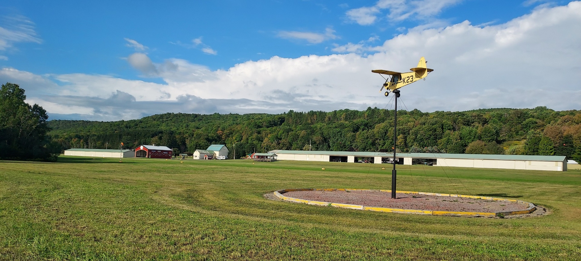K23 model airplane weathervane with hangars in background