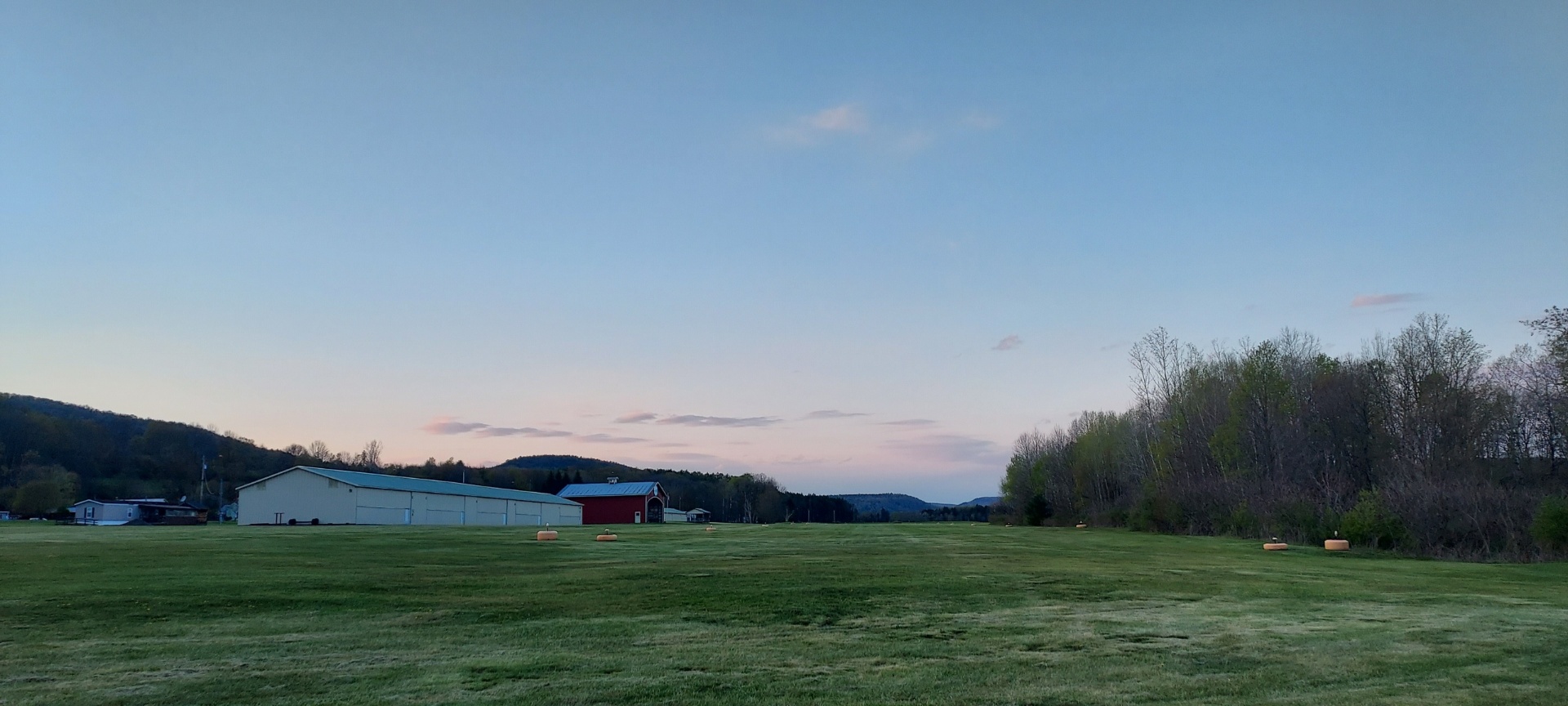 Dusk over the airfield with hangars silhouetted