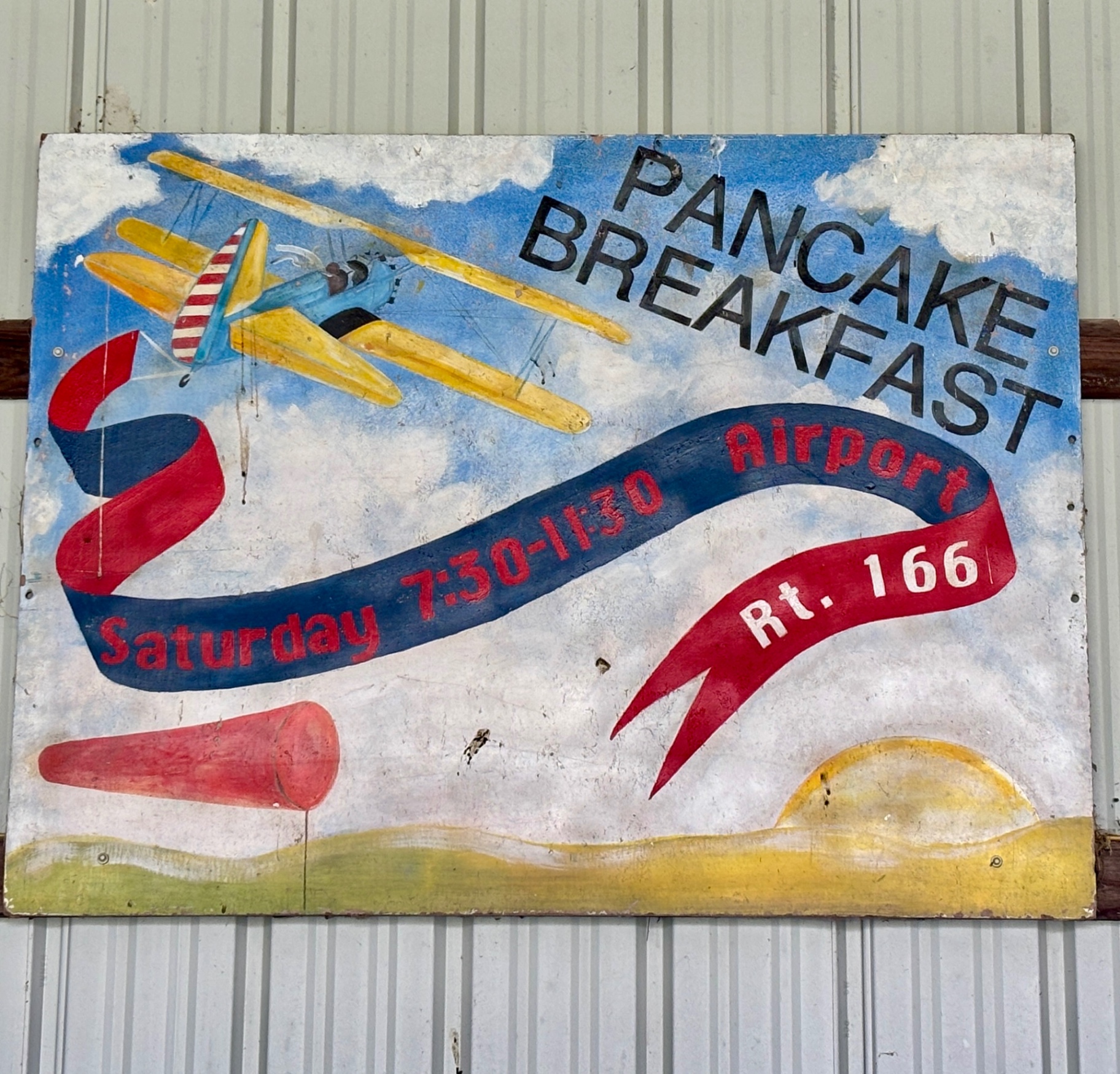 Vintage hand-painted Pancake Breakfast sign with biplane art
