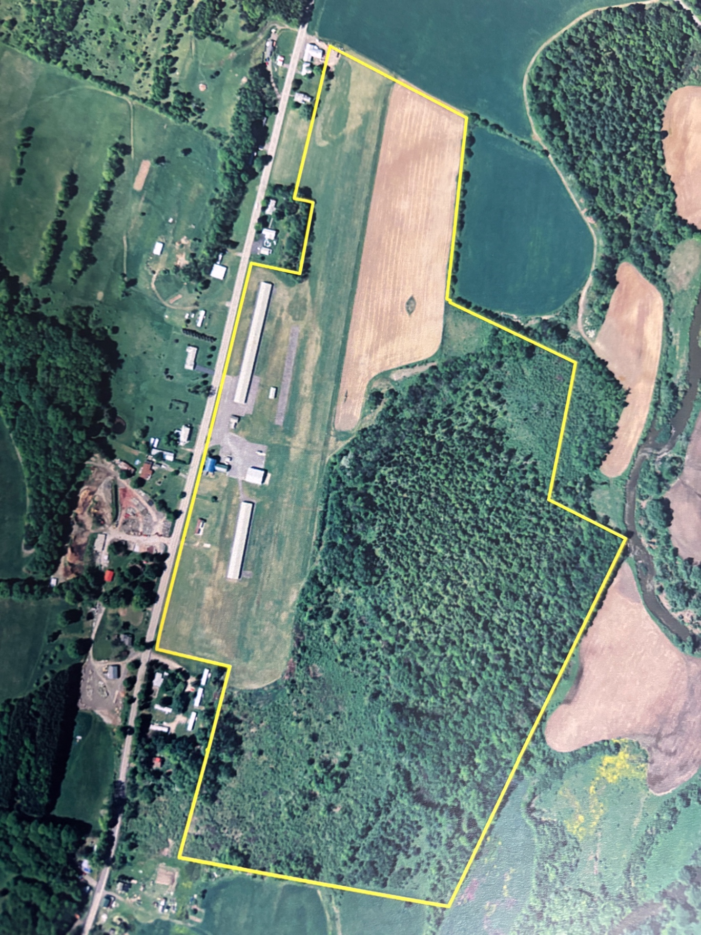 Aerial map view of K23 airfield property outlined in yellow with runway, hangars, and surrounding fields