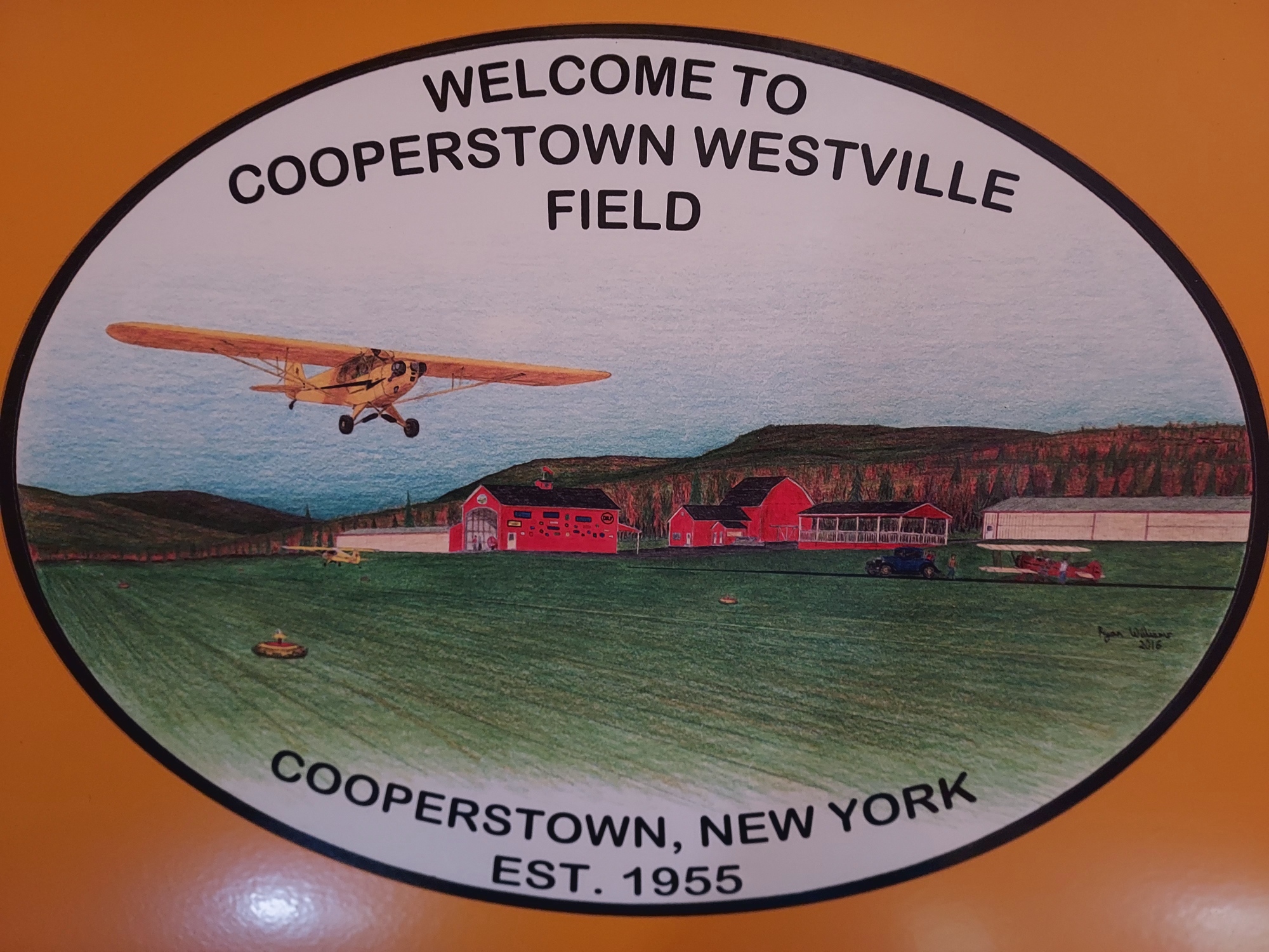 Welcome to Cooperstown Westville Field hand-painted oval sign with Piper Cub illustration