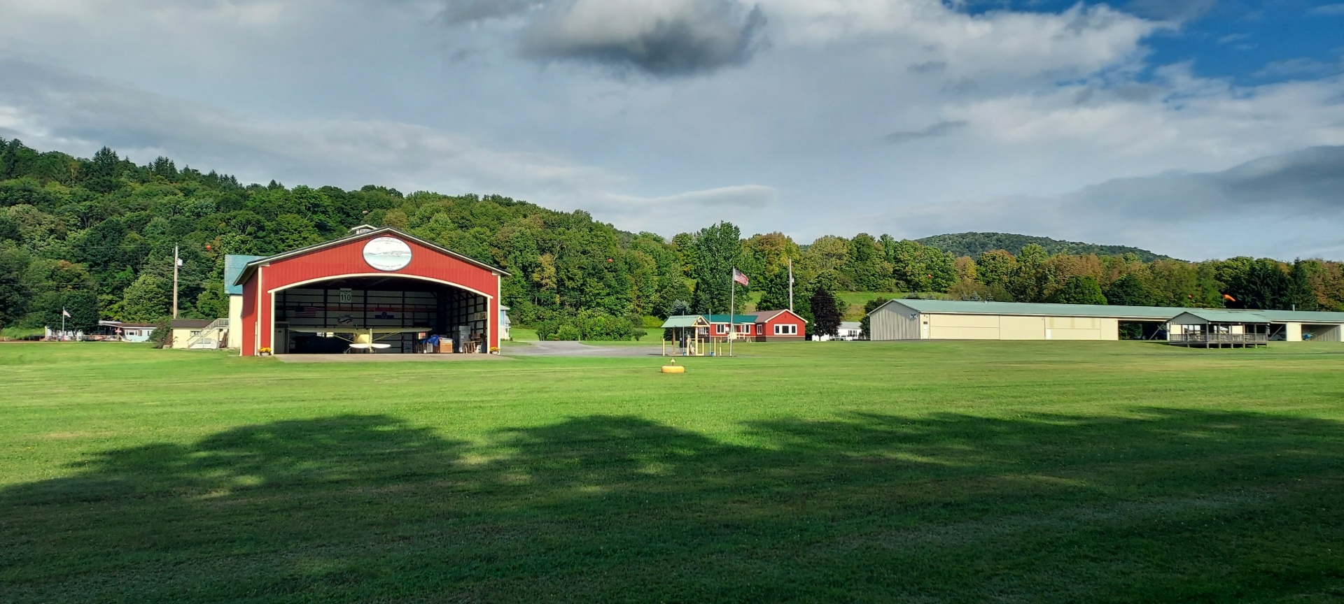 Main hangar with aircraft visible inside on a summer day